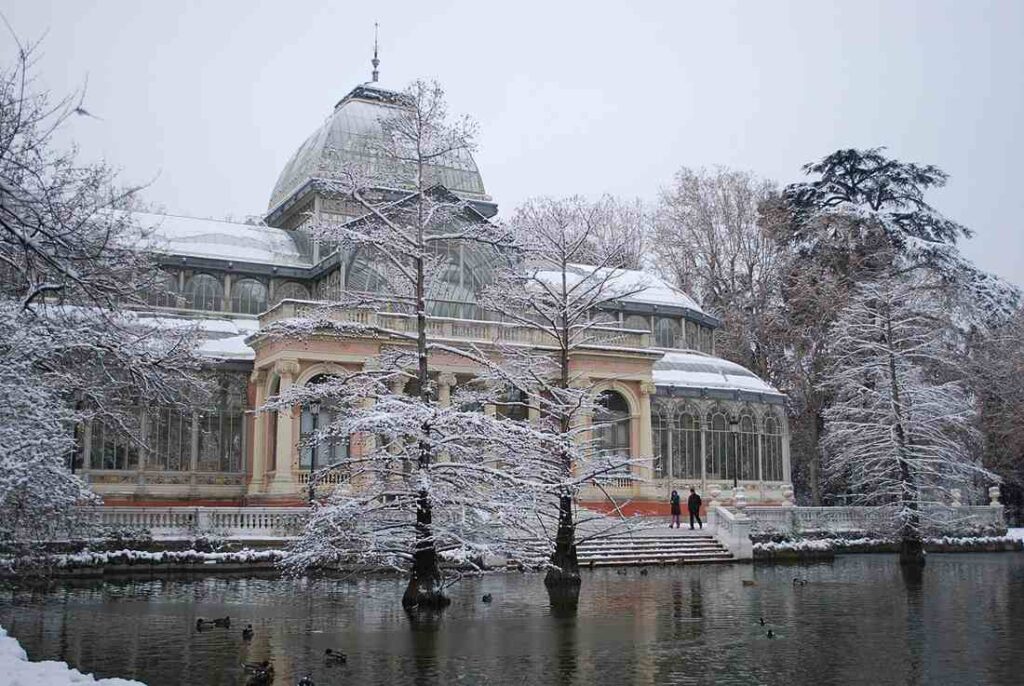Palacio de Cristal ("Crystal Palace") in the Retiro Park in Madrid (Spain), after a snowfall.